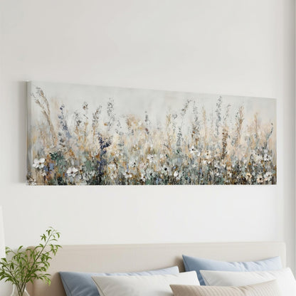 a large, long painting of a field of flowers hanging on a wall above a bed with pillows.