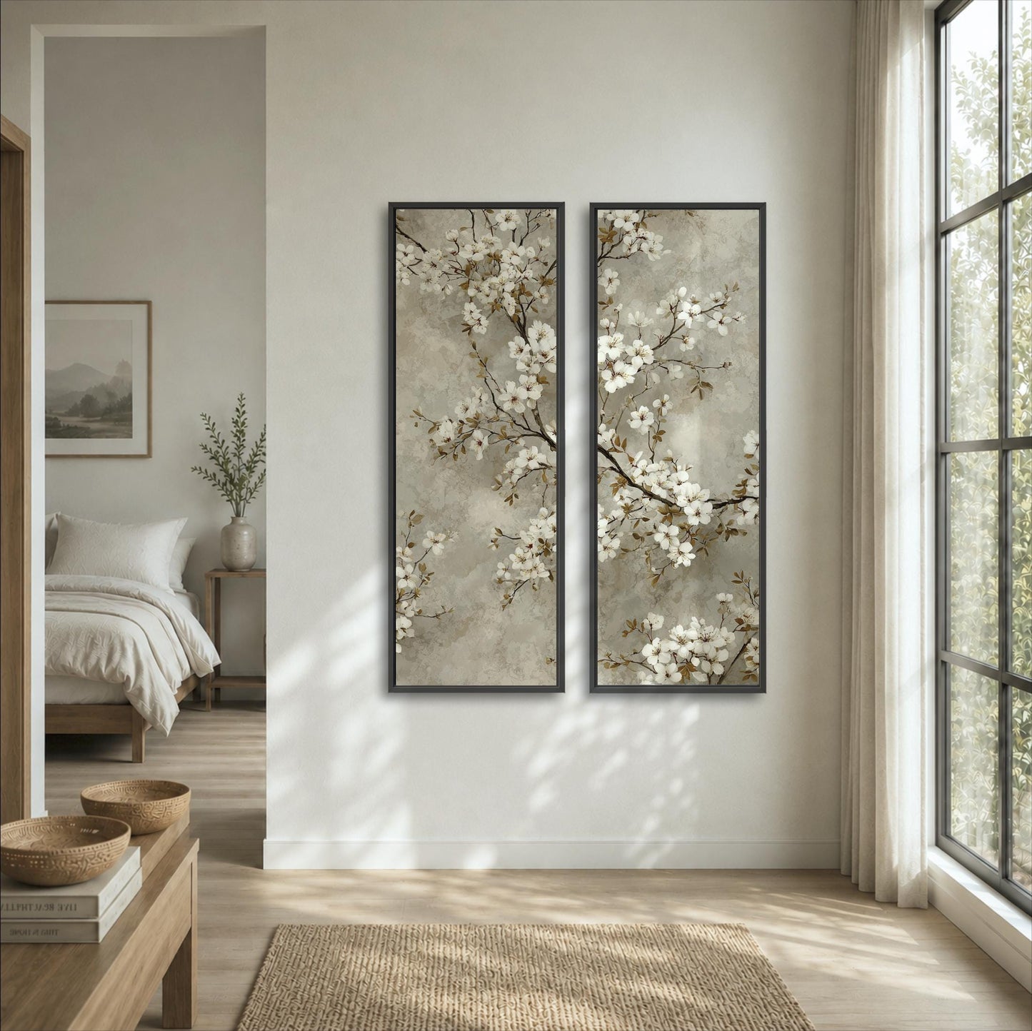 a serene bedroom with a large window, a bed, and two framed paintings of white flowers hanging on the wall.