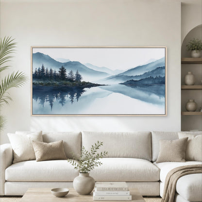a large landscape painting hanging on a wall above a white sofa in a living room.