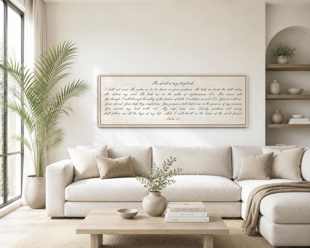 a living room with a large white sofa, a wooden coffee table, and a framed Bible verse displayed on the wall.