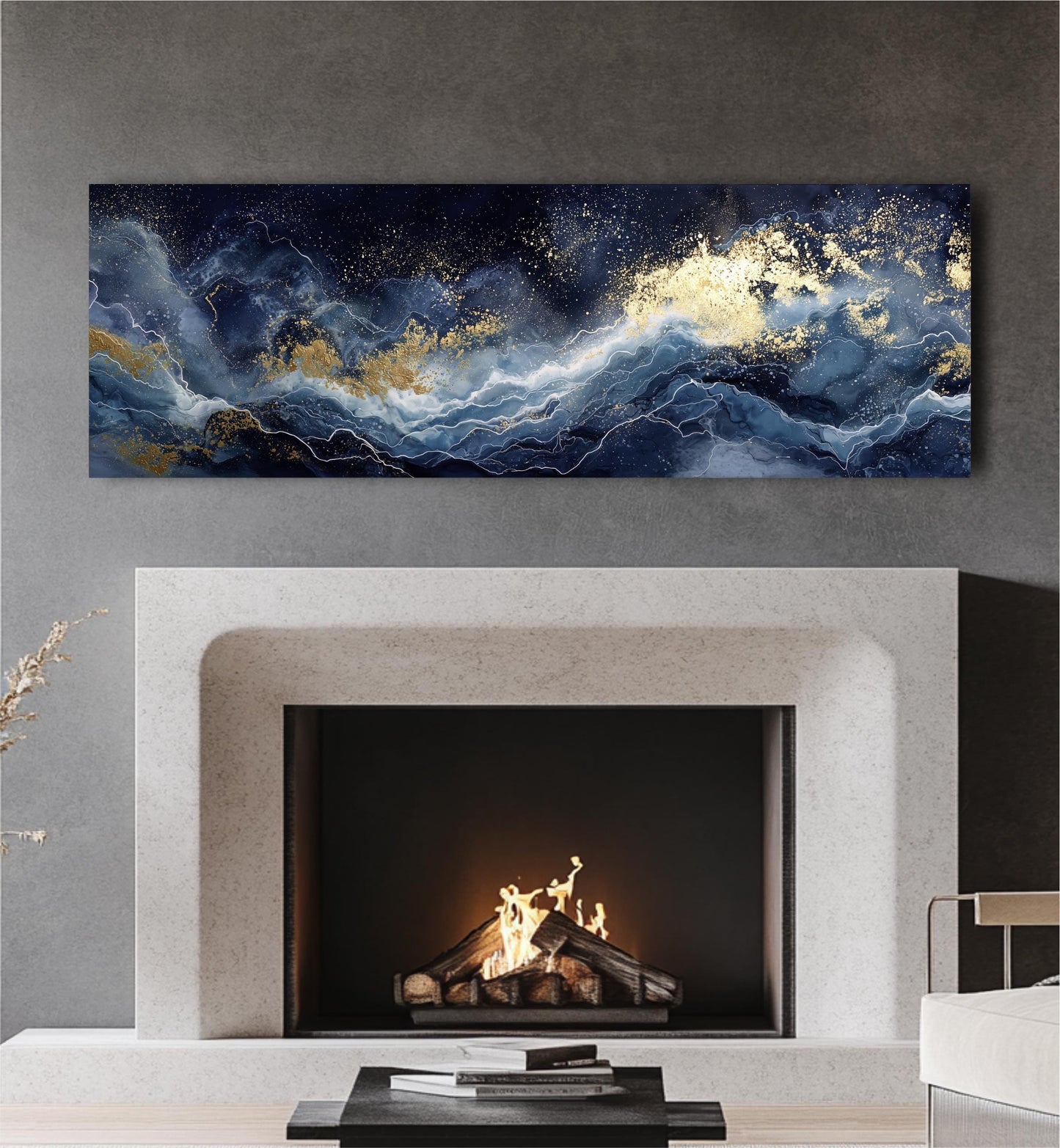 a fireplace with a fire burning inside, and a large abstract painting above it. The painting has a dark blue and white color scheme with gold accents, creating a striking contrast against the dark background. The fireplace is situated in a modern living room setting, with a white sofa and a coffee table visible in the background.