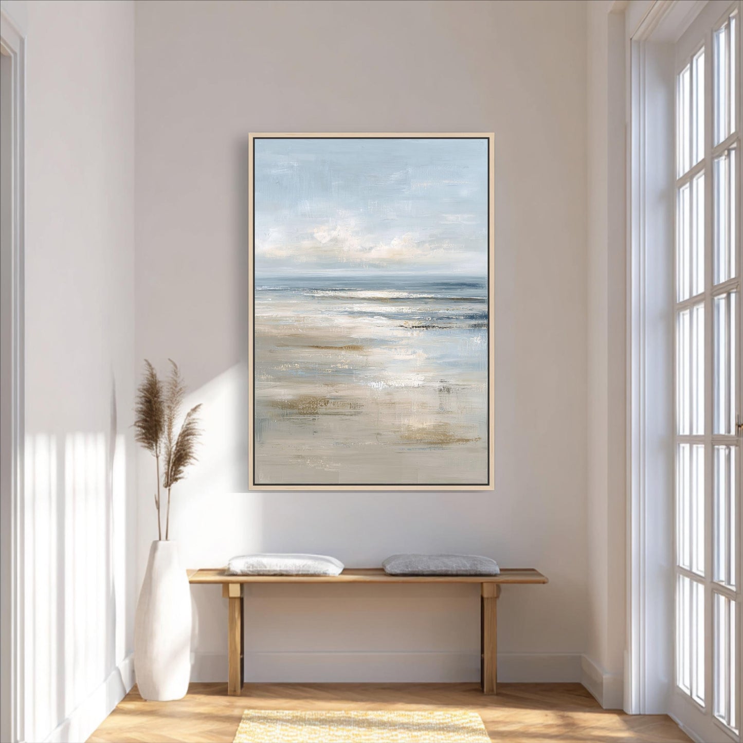 a serene and minimalist interior design with a large painting of a beach scene hanging on the wall above a wooden bench.