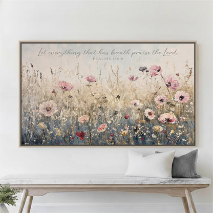 a large framed painting of a field of flowers hanging on a wall above a wooden bench.
