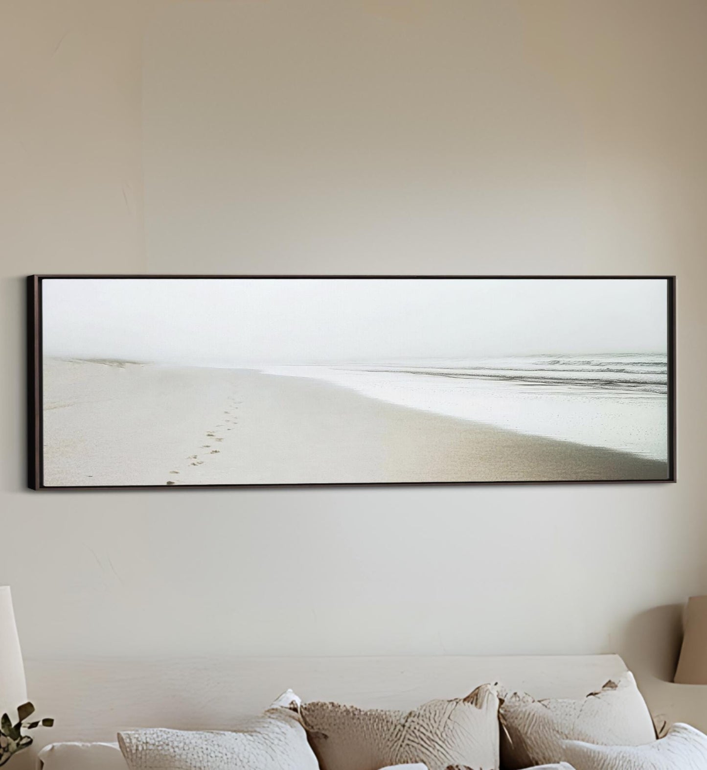 a bed with a white comforter and a picture on the wall