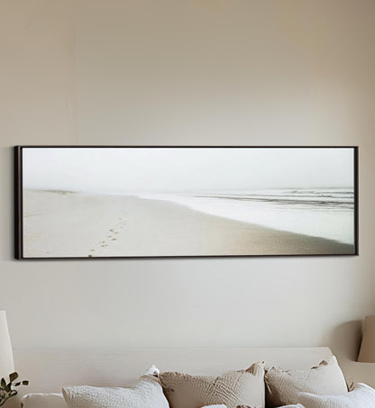 a bed with a white comforter and a picture on the wall