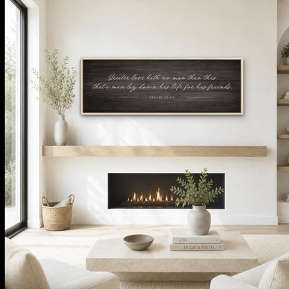 A cozy living room with a fireplace, a wooden shelf, and a framed inspirational quote on the wall.