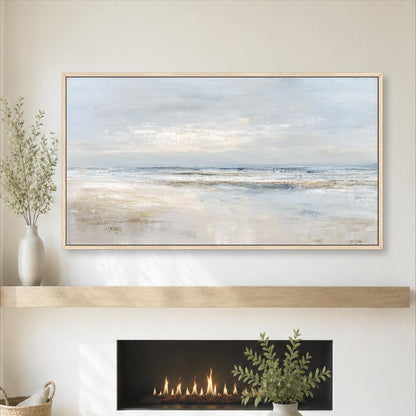 a large painting of a serene beach scene hanging on a wall above a fireplace. The painting depicts a tranquil beach with a calm ocean and a cloudy sky. The fireplace has a fire burning, adding warmth and ambiance to the room. The overall setting appears to be a cozy and inviting space, with the painting and fireplace as the focal points.