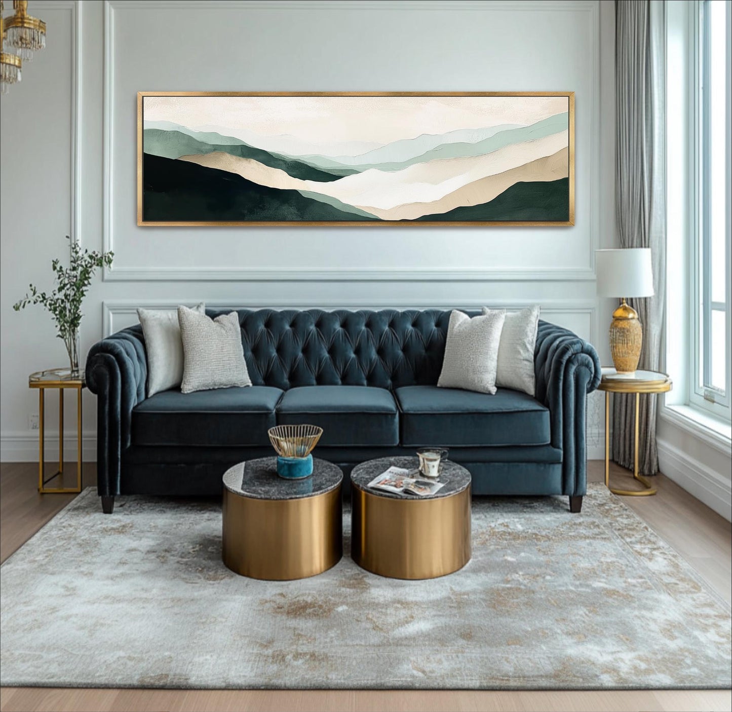 A modern living room with a blue tufted sofa, two round coffee tables, and a large landscape painting on the wall.