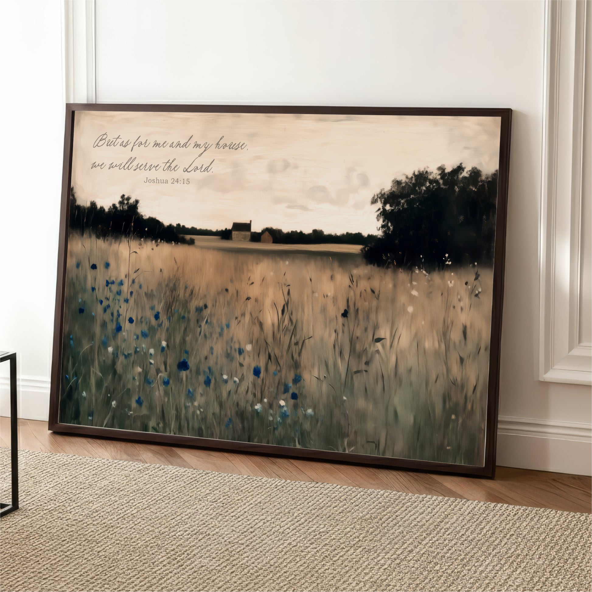 A framed painting depicting a serene landscape with a field of tall grass and trees in the background, accompanied by a Bible verse from Joshua 24:15.