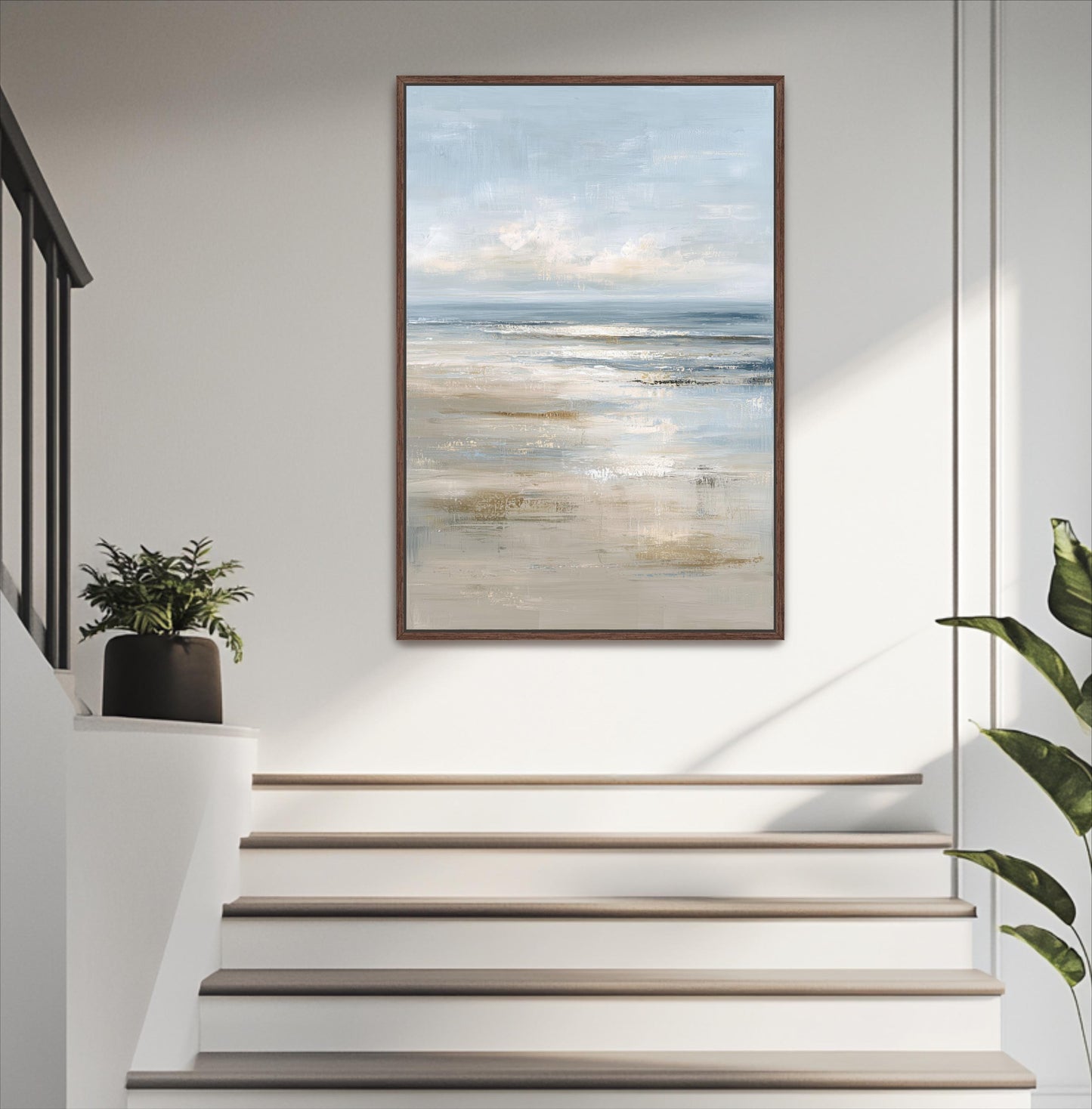 a painting of a beach scene hanging on a white wall, with a set of stairs leading up to it.