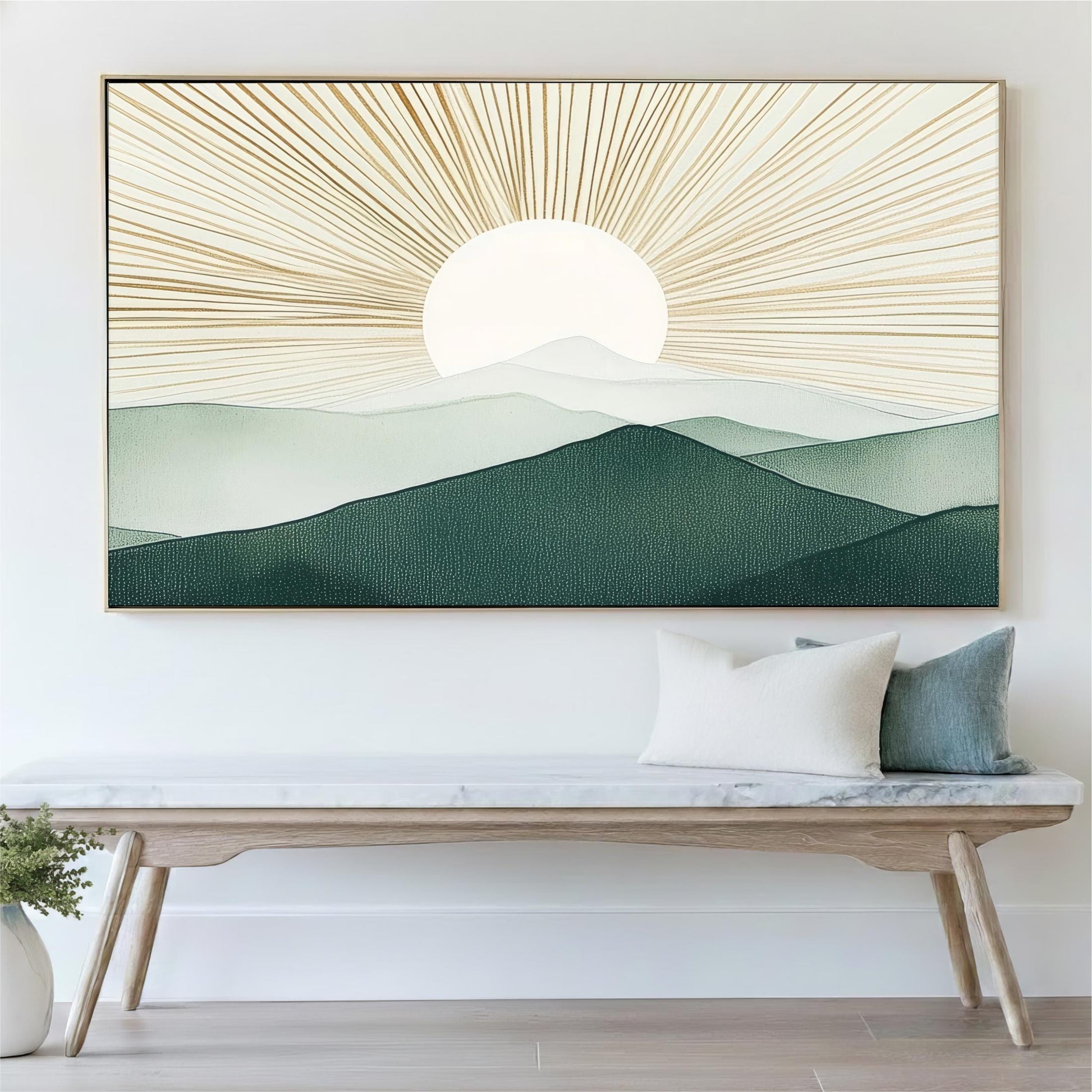 a large framed painting of a mountain landscape with a sun in the background, hanging on a wall above a wooden bench with pillows.