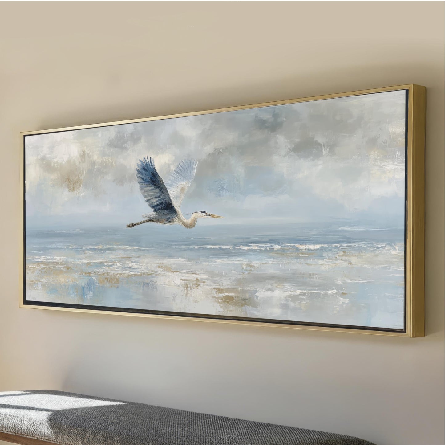 A large framed painting depicting a bird in flight over a serene body of water, with a cloudy sky in the background.