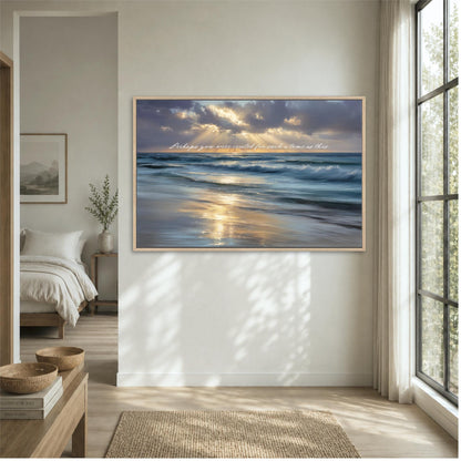 a serene bedroom scene with a large framed picture of a tranquil beach scene hanging on the wall, depicting a sunset over the ocean.