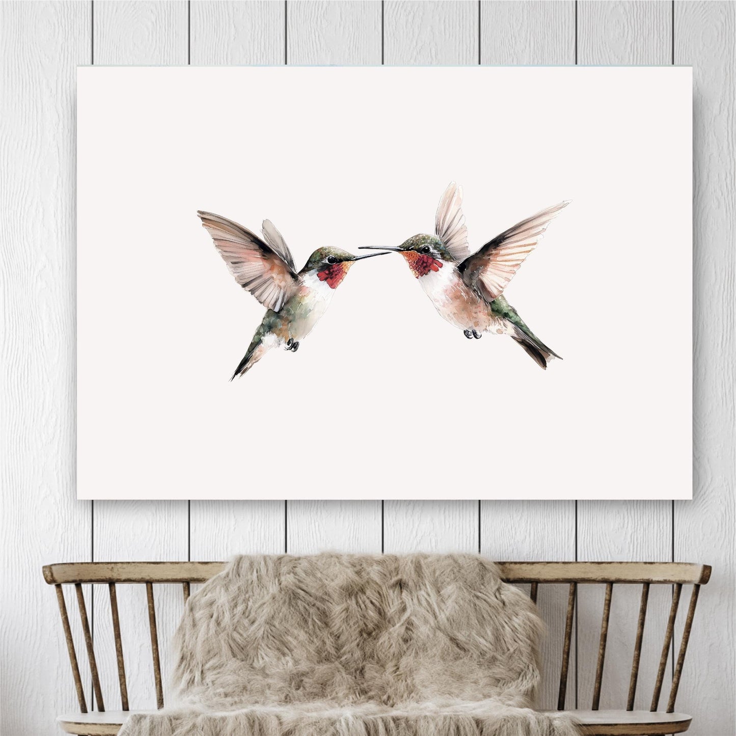 two hummingbirds in mid-flight, their wings spread wide as they appear to be kissing or touching each other.