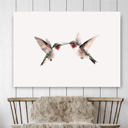 two hummingbirds in mid-flight, their wings spread wide as they appear to be kissing or touching each other.