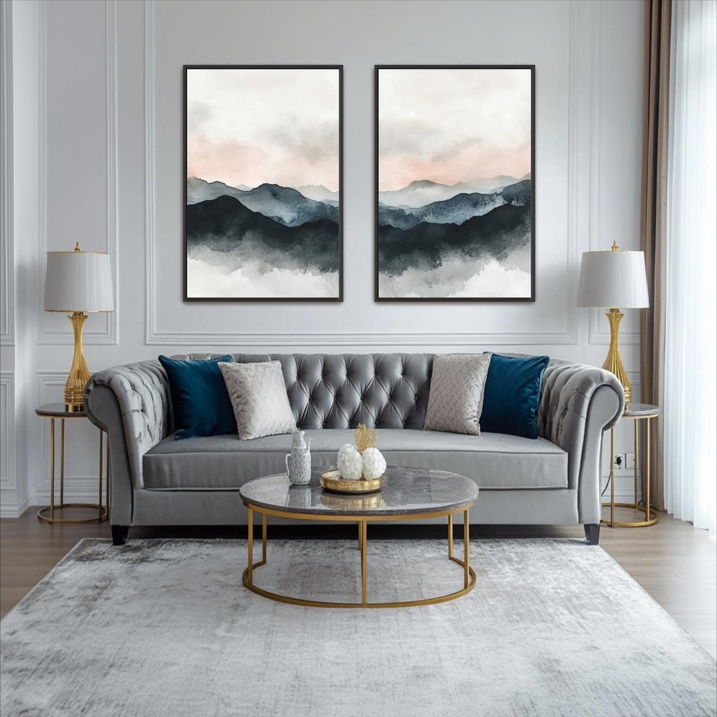 a modern living room with a gray tufted sofa, a round glass coffee table, and two framed landscape paintings on the wall above the sofa.