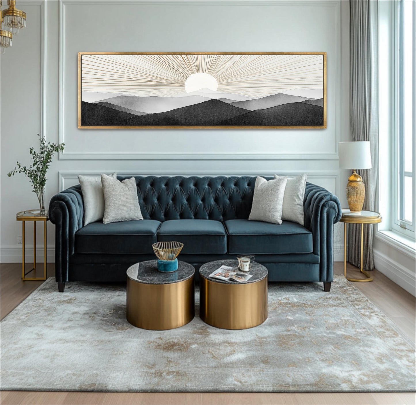A modern living room with a blue tufted sofa, two round coffee tables, and a large framed landscape painting on the wall.