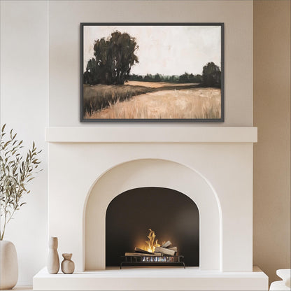 a cozy living room with a white fireplace and a framed landscape painting above it. The painting depicts a serene countryside scene with trees and a field. The fireplace has a black screen and a fire burning inside, creating a warm and inviting atmosphere in the room.