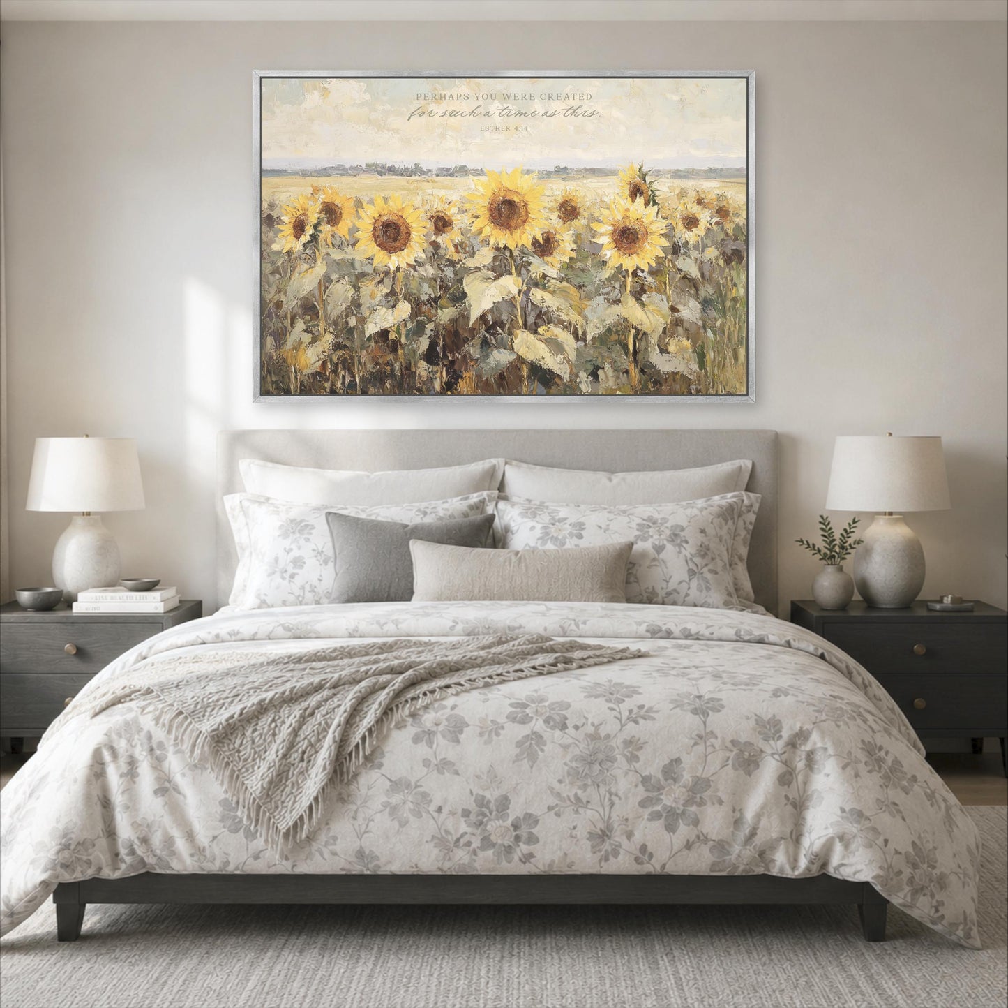 a large painting of a field of sunflowers hanging above a bed with a floral comforter.