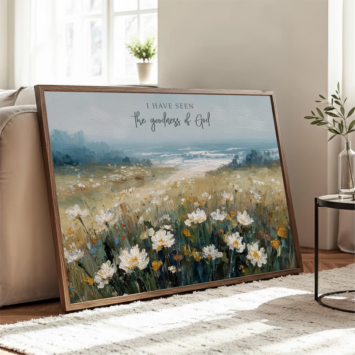 a large painting of a field of white flowers, with a text overlay that reads "I have seen the goodness of God".