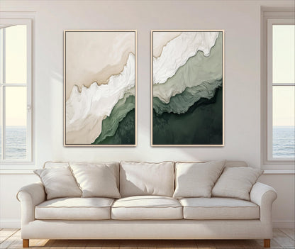 two large abstract paintings hanging on a wall above a white sofa in a living room.