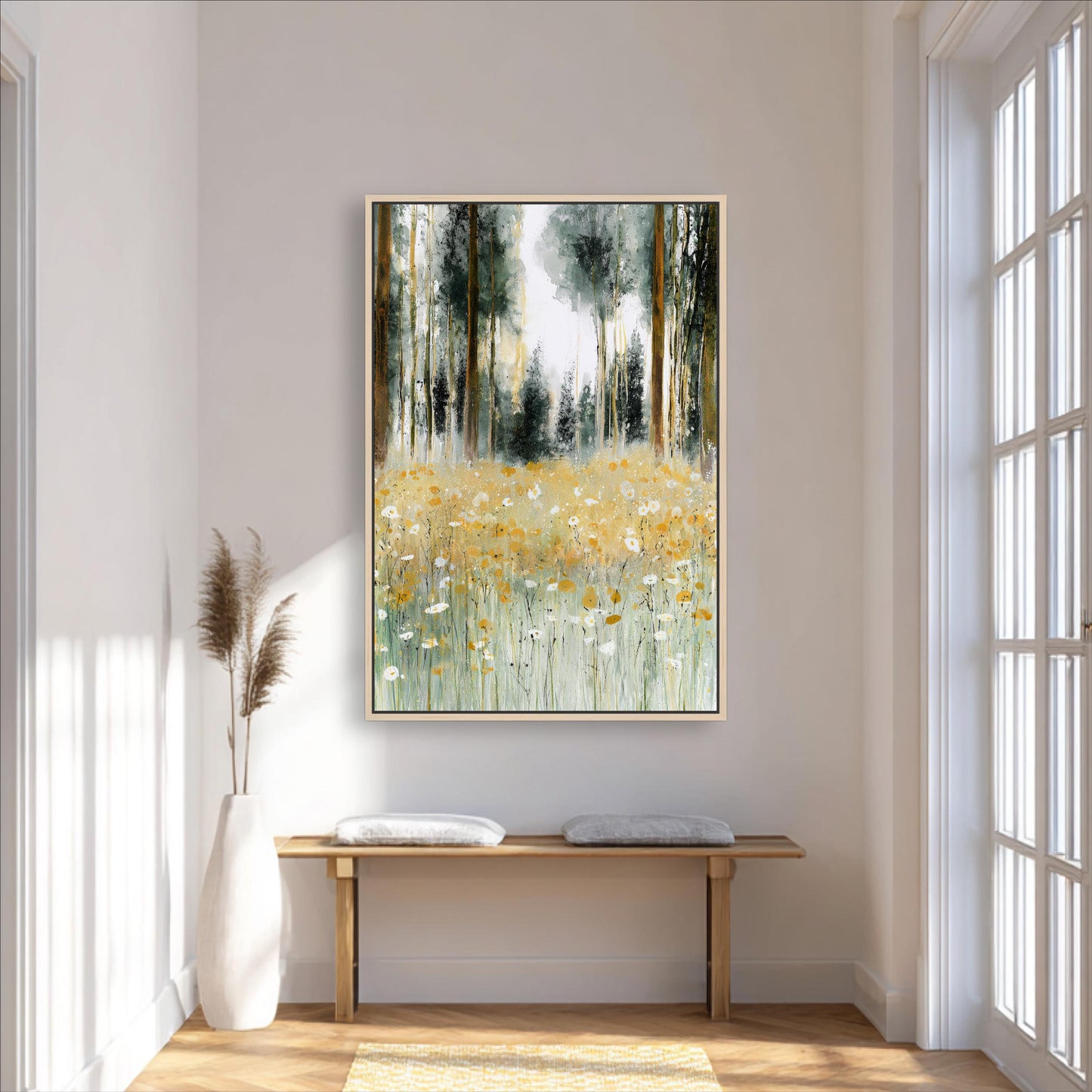 a large painting of a field with tall trees and yellow flowers hanging on a white wall in a room with a wooden bench and a white vase.