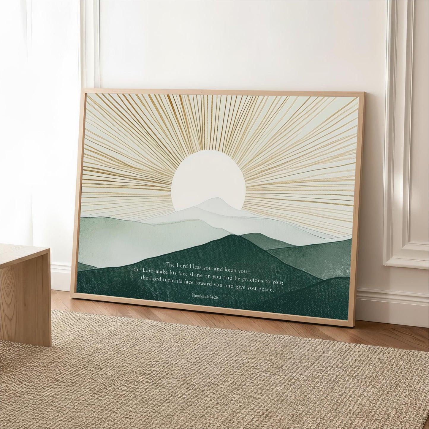 The image is a framed poster with a serene landscape depicting a sun rising over a mountain range. The text on the poster reads "The Lord blows you and keeps you, the Lord makes his face shine on you and begraces to you, the Lord turns his face on you and give you peace."