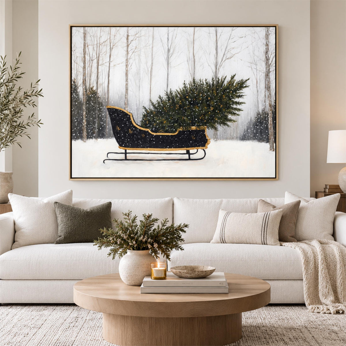 a cozy living room with a large framed picture of a Christmas tree on the wall above a white sofa. The sofa is adorned with a vase of greenery and a candle, creating a warm and festive atmosphere.