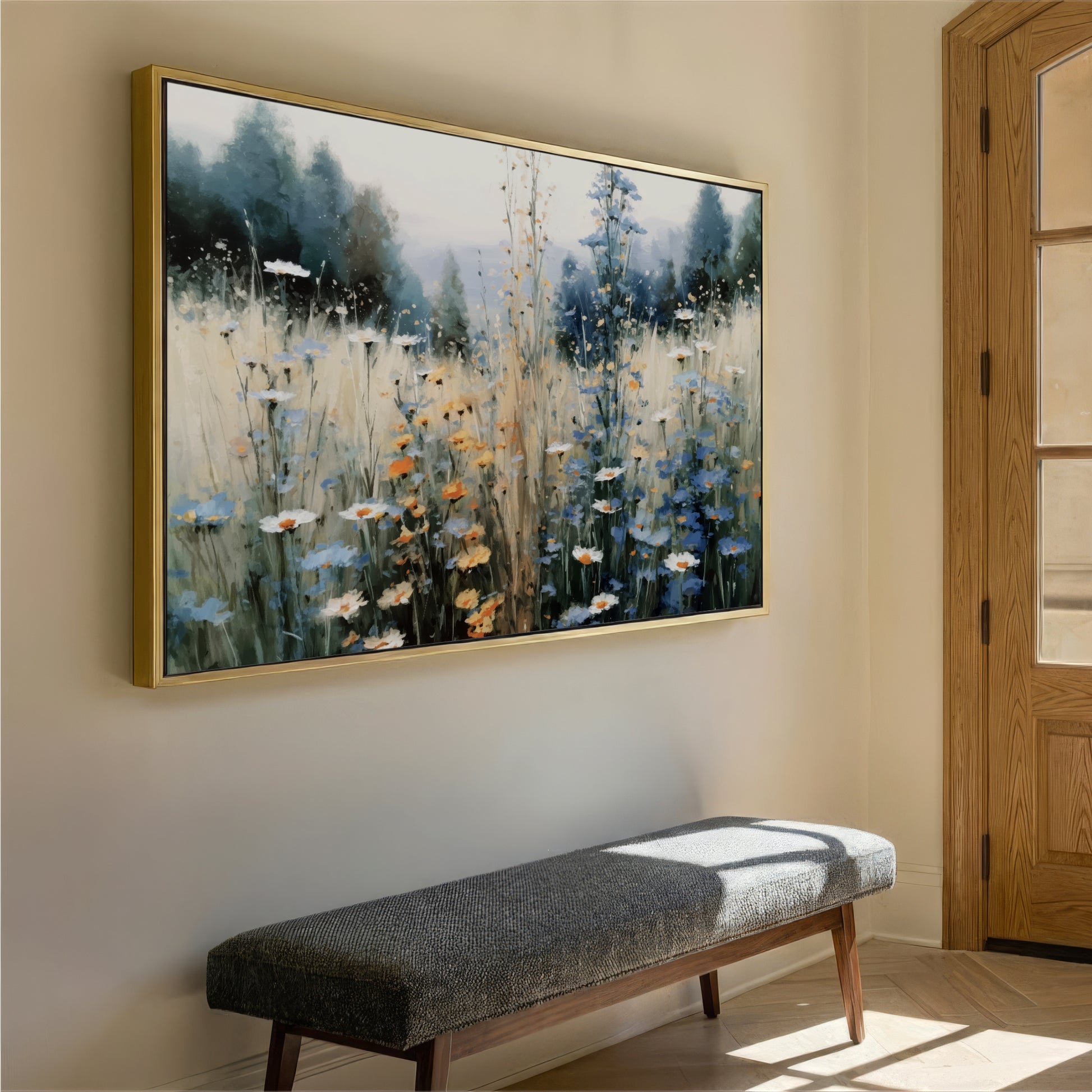 a large painting of a field of flowers hanging on a wall, with a wooden bench placed in front of it.