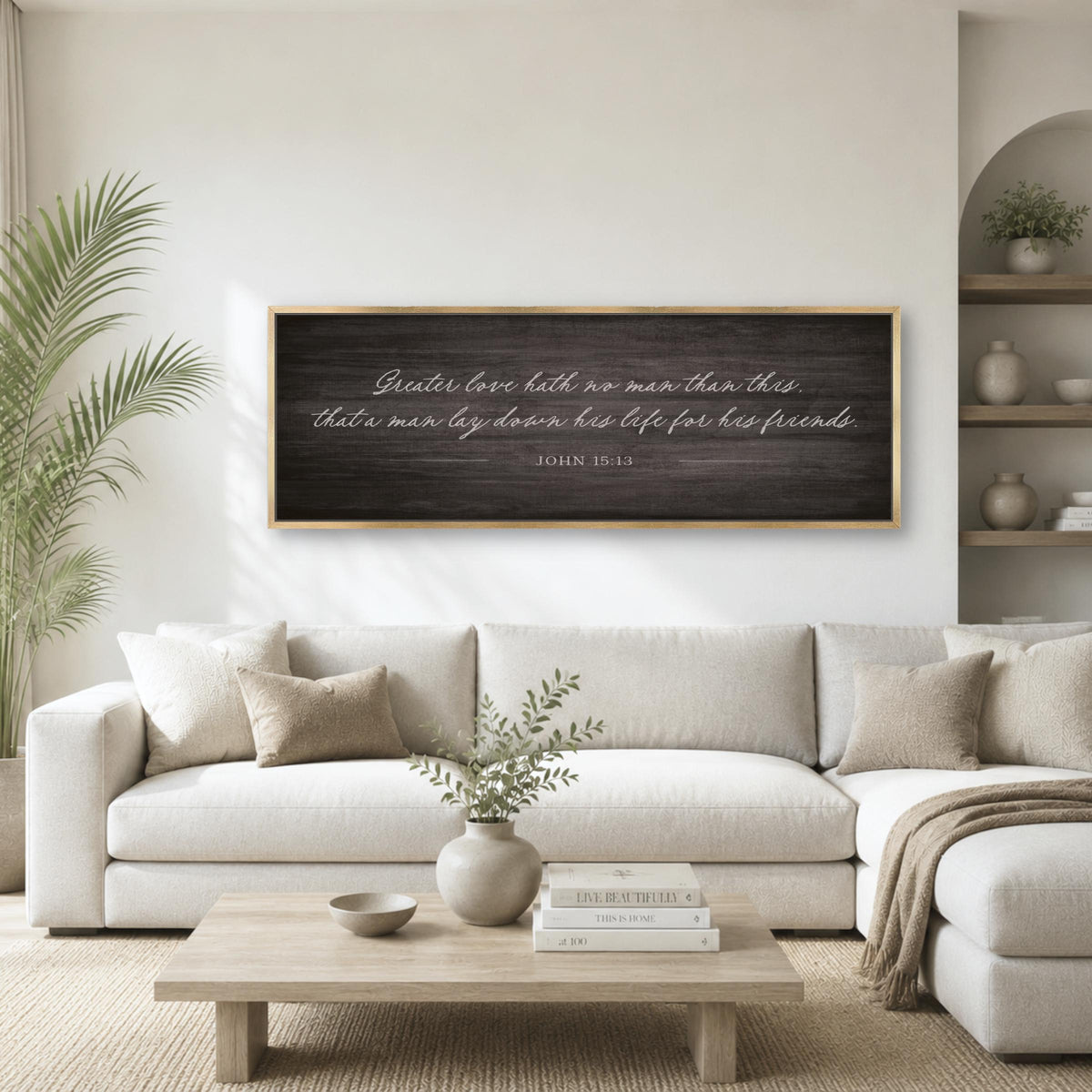a living room with a white sofa, a wooden coffee table, and a framed quote on the wall.