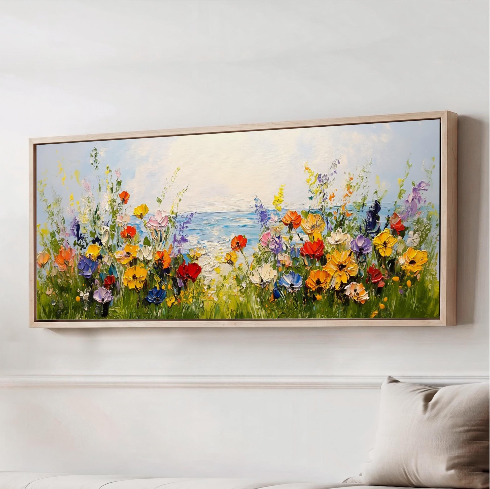 The image is a large painting depicting a vibrant field of colorful flowers, with a body of water in the background.