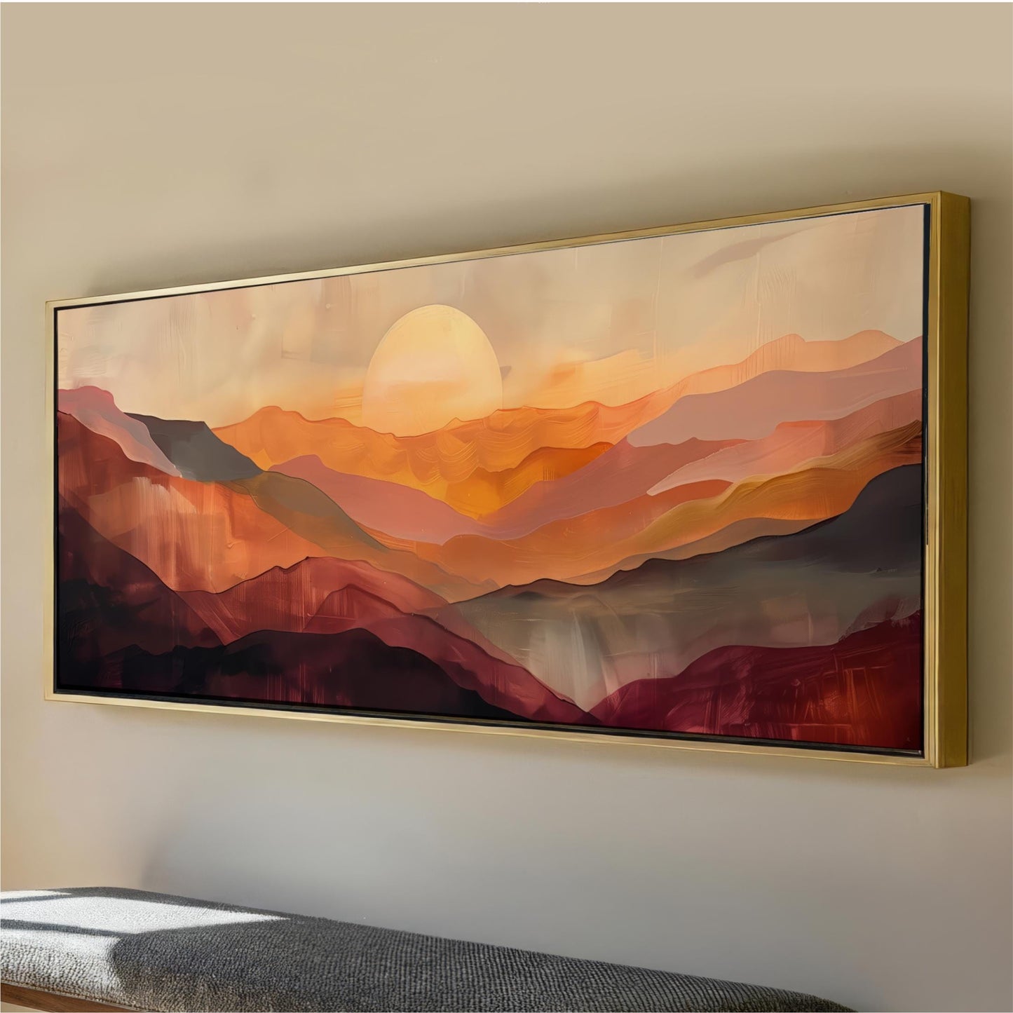 a large, framed painting of a mountainous landscape with a warm, sunset-like glow.
