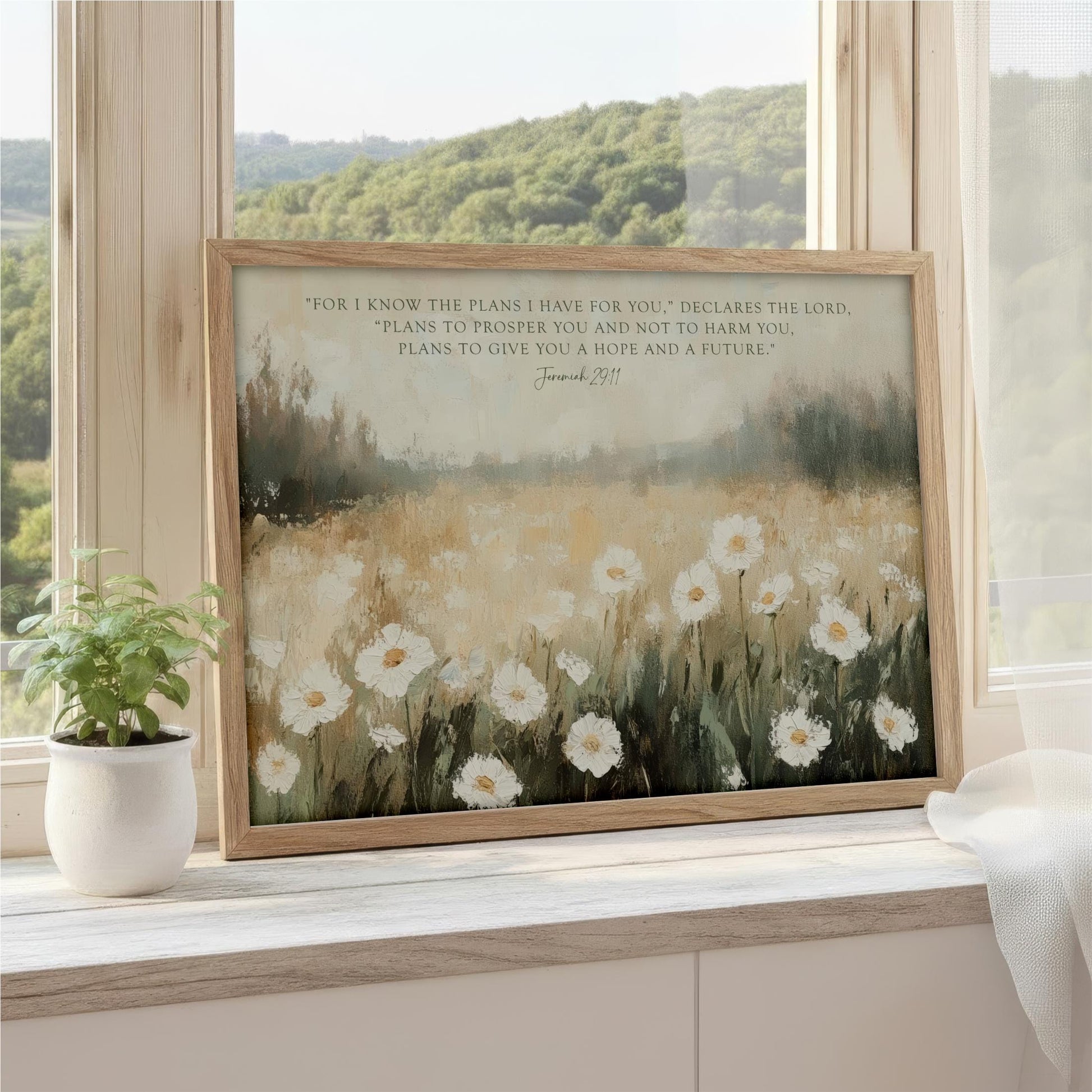 a framed painting of a field of white flowers, with a quote from the Bible verse James 2:11 displayed on the painting.