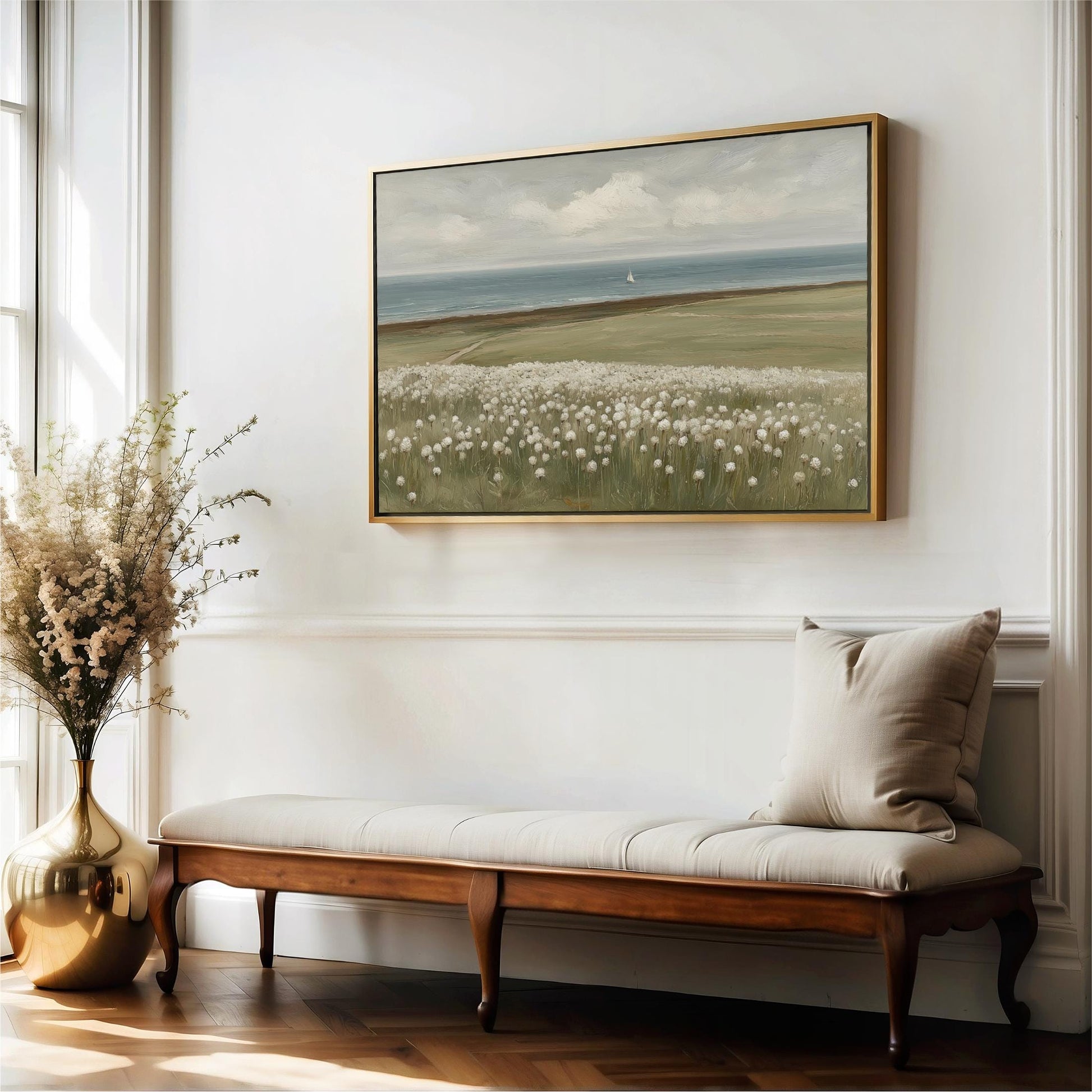 a serene indoor setting with a large painting of a field of flowers hanging on the wall above a wooden bench. The painting is framed in gold and is the focal point of the room. The bench is positioned next to a large vase filled with white flowers, adding a touch of natural beauty to the space. The overall atmosphere of the room is calm and inviting, with the painting and flowers creating a harmonious and visually appealing composition.