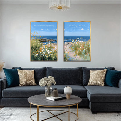 a living room with a black sectional sofa, a round coffee table, and two framed paintings of a beach scene hanging on the wall above the sofa.