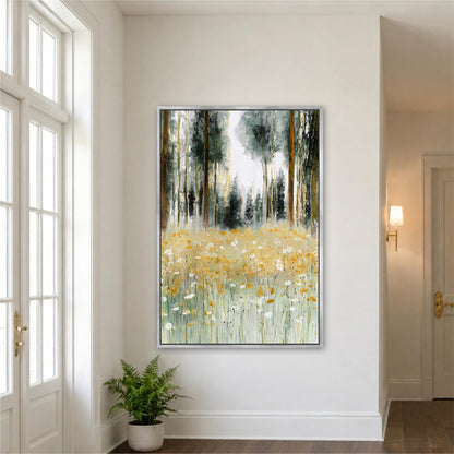 a large painting of a forest scene with tall trees and a field of yellow flowers. The painting is hung on a white wall in a room with a window and a plant.