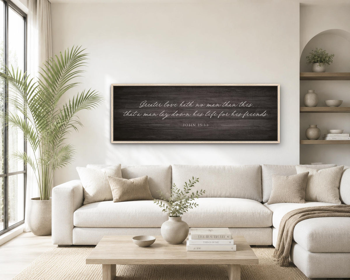 A living room with a large white sofa, a wooden coffee table, and a framed inspirational quote on the wall.