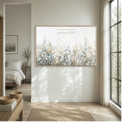 a large framed painting of a field of flowers hanging on a wall in a bedroom.