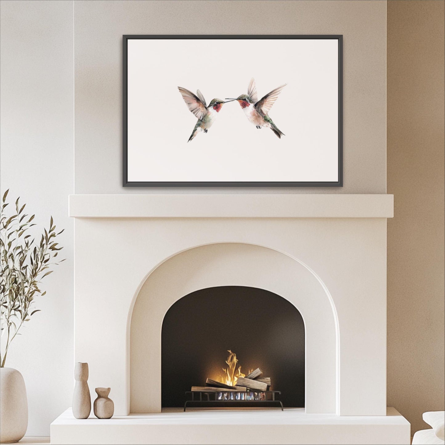 a white fireplace with a framed photograph of two hummingbirds perched on the mantel above it.
