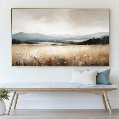 a large landscape painting hanging on a wall above a wooden bench with pillows.