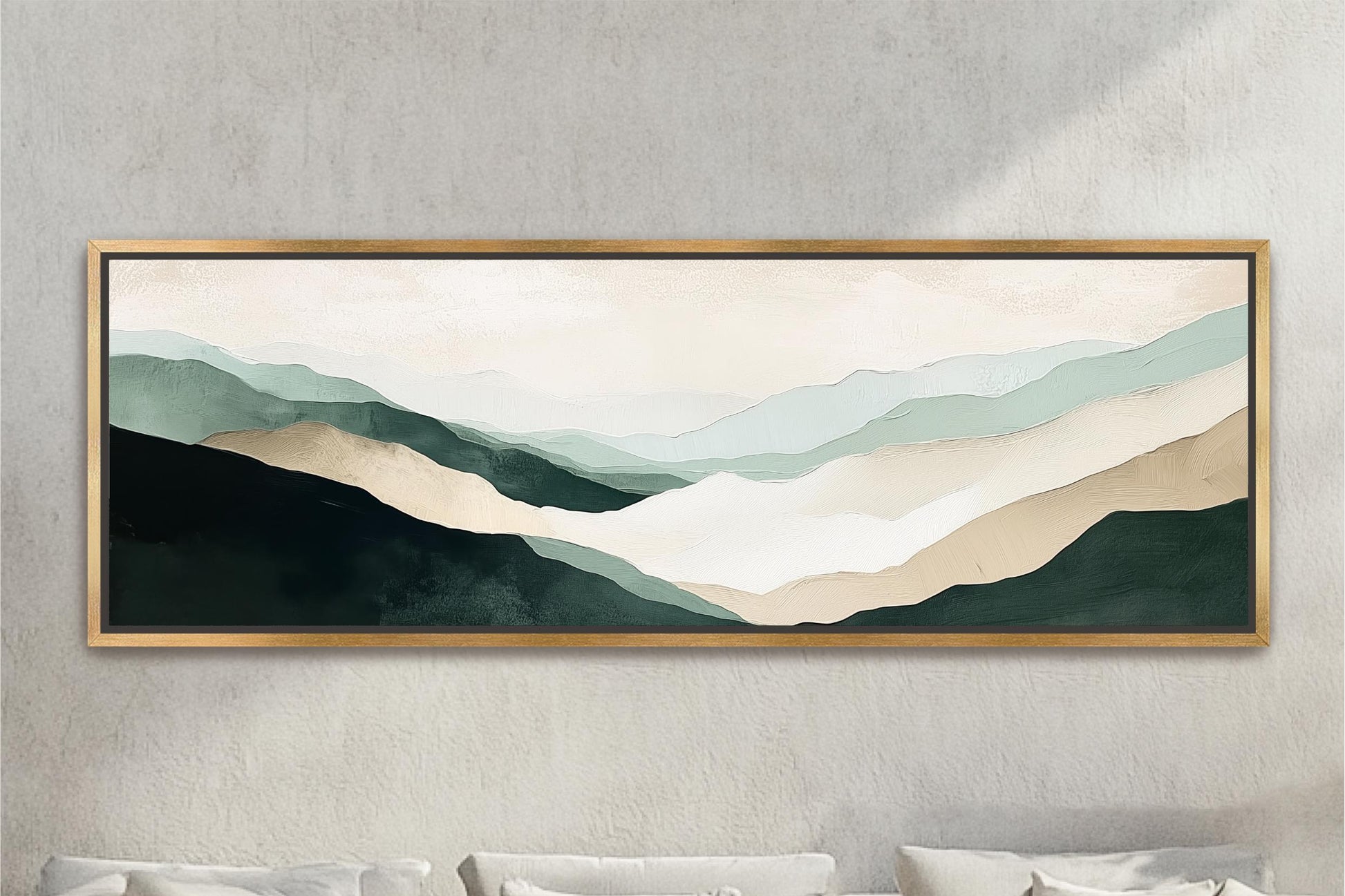 a large, framed painting of a mountain landscape hanging on a wall above a beige sofa with white pillows.