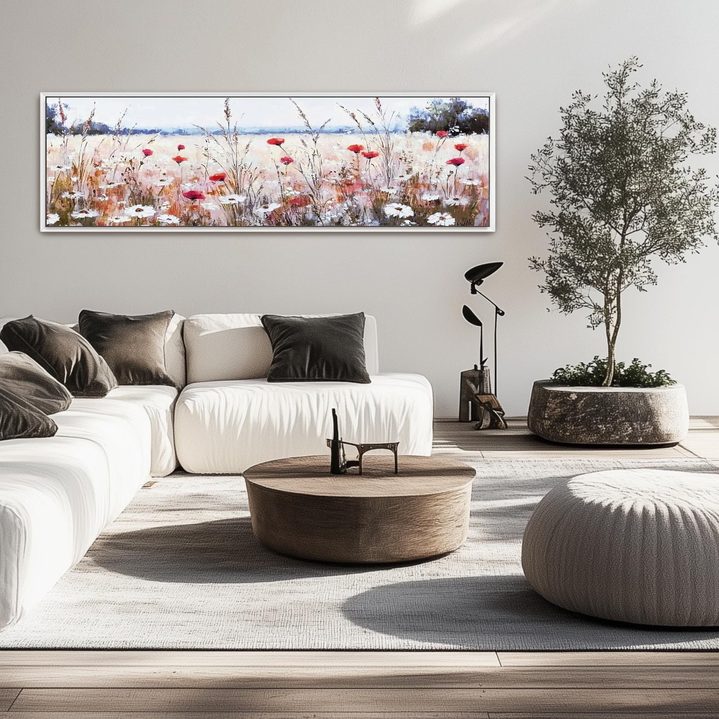 a living room with a white couch and a painting on the wall