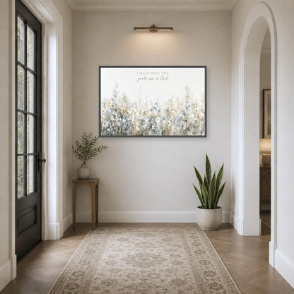 A hallway with a large painting of a field of flowers hanging on the wall, a small table with a plant, and a rug on the floor.