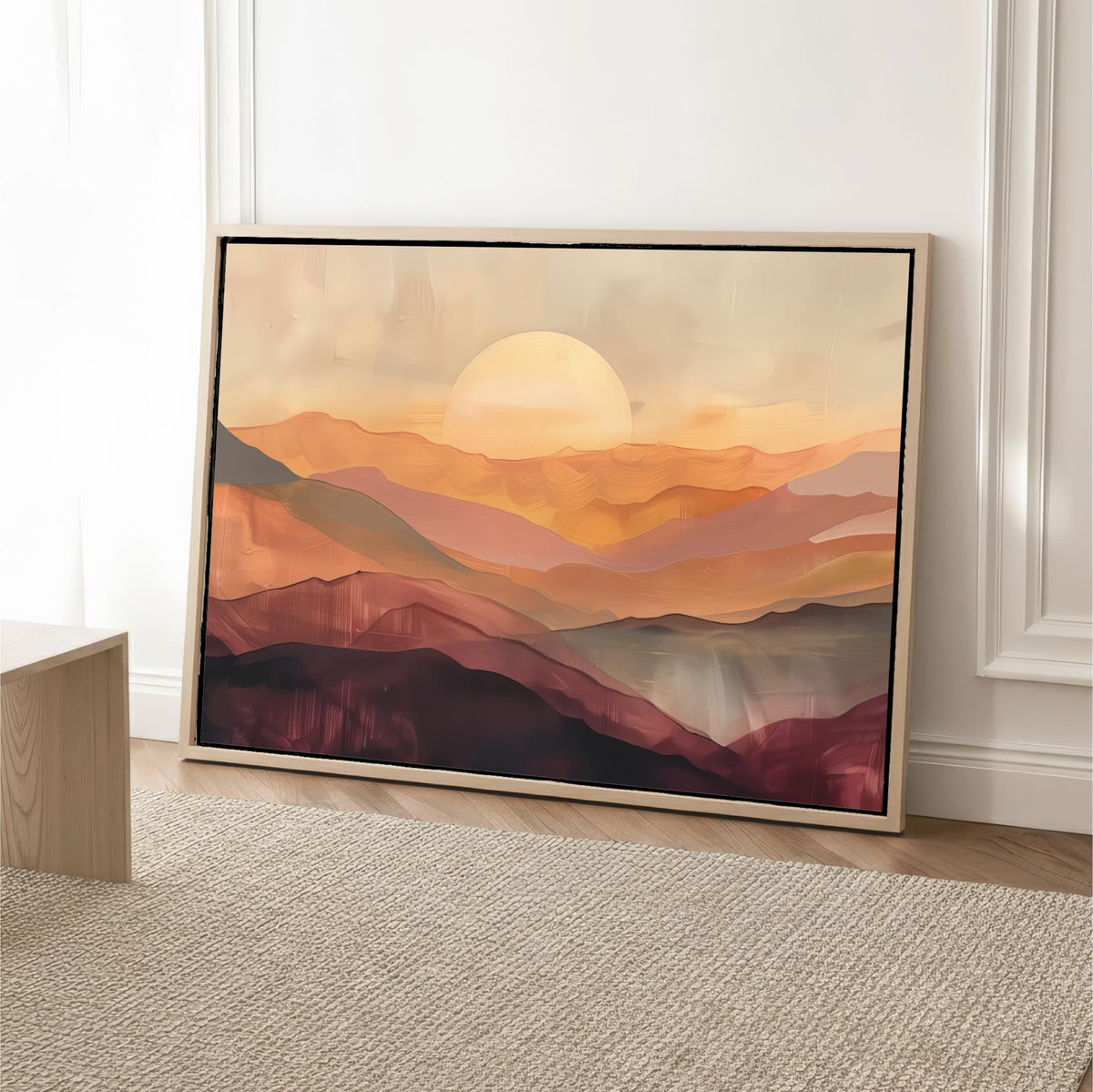 a large, framed painting of a mountainous landscape with a sunset in the background.