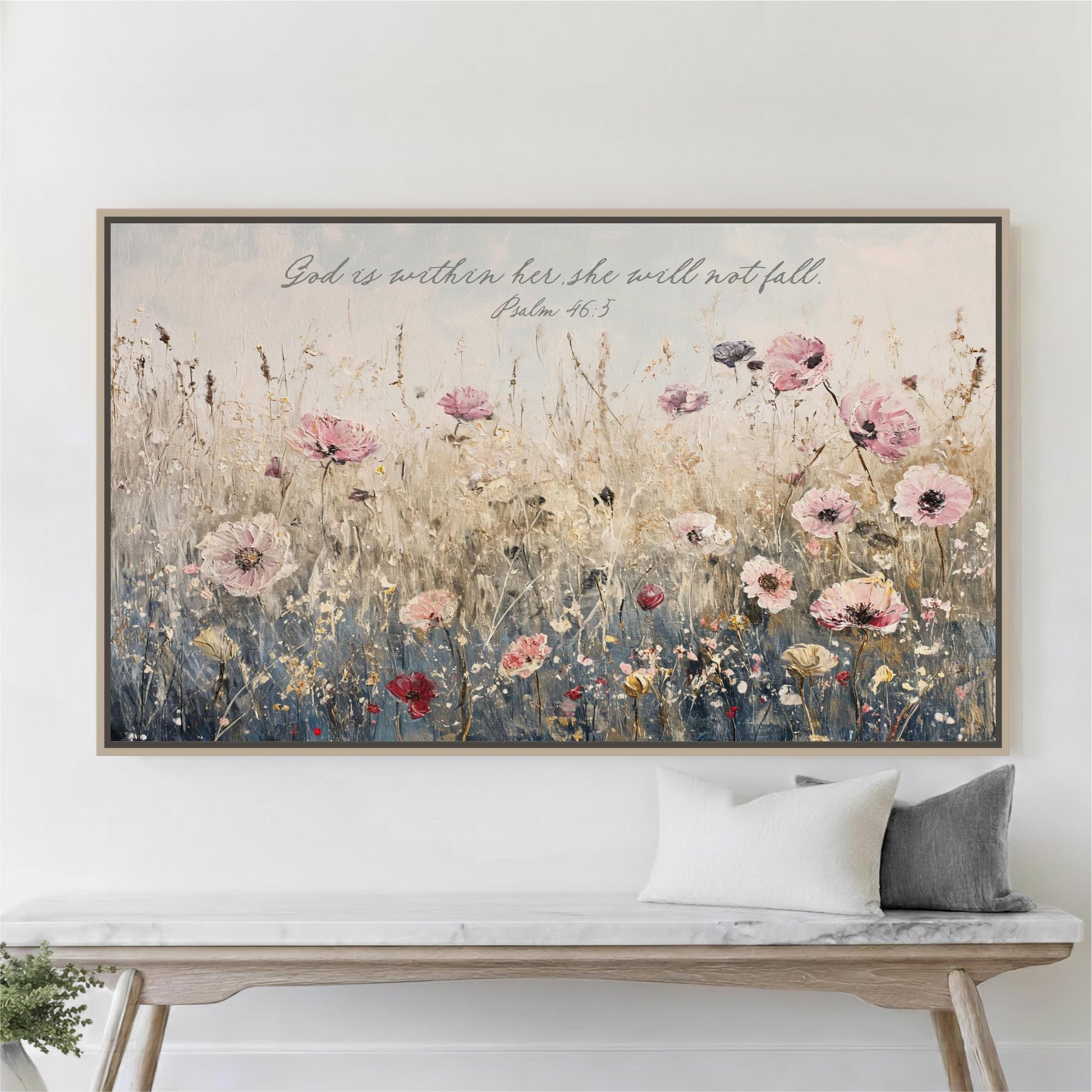 a large framed painting of a field of flowers hanging on a wall above a wooden bench.