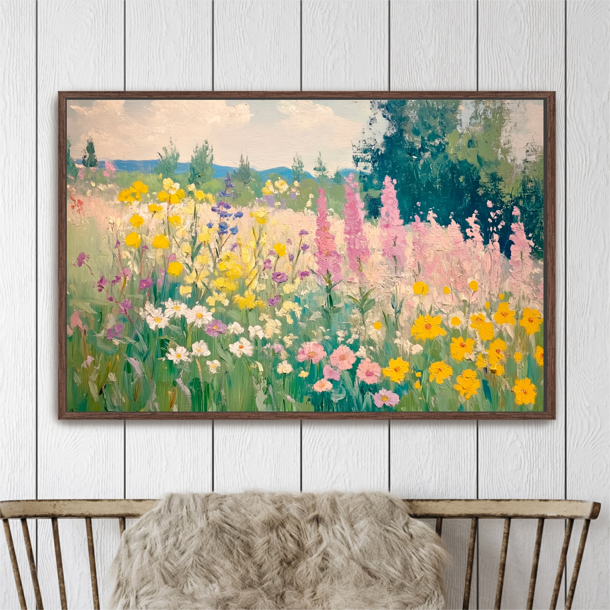 The image is a framed painting depicting a vibrant field of colorful flowers, including yellow, pink, and white blooms, set against a backdrop of trees and a blue sky.