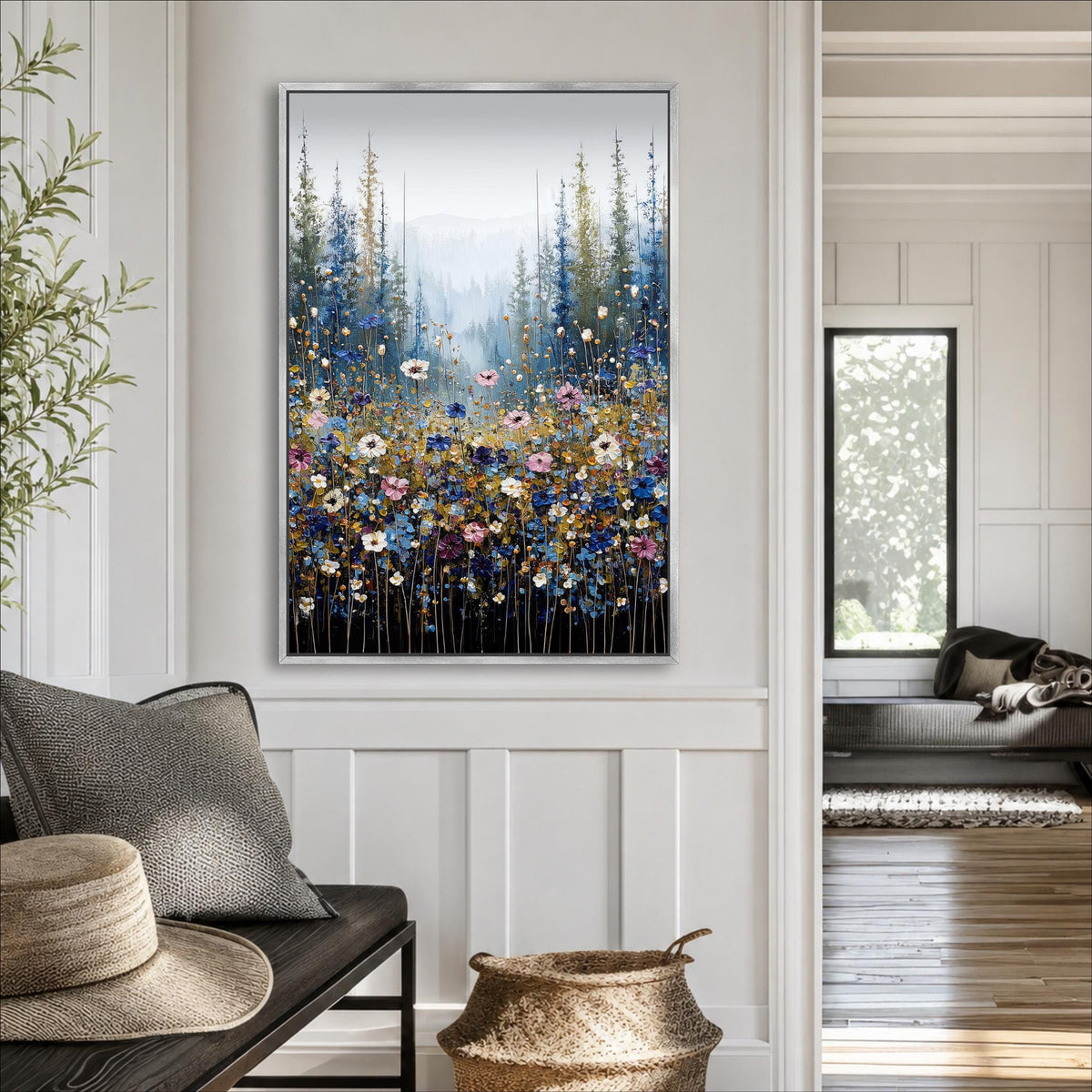 a large framed painting of a field of flowers hanging on a wall in a room with a wooden floor and white walls.