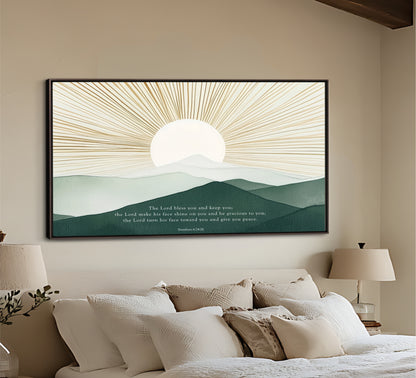 a large framed artwork depicting a serene landscape with a sun rising over mountains, hanging on the wall above a bed with white pillows and a beige headboard.