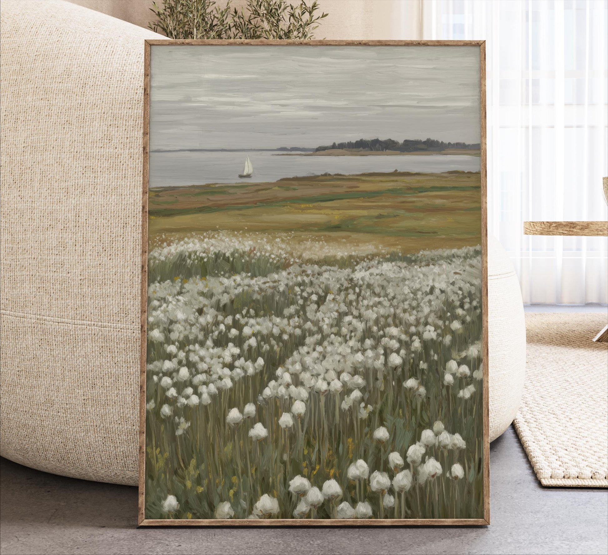 The image is a framed painting depicting a serene landscape with a field of white flowers, a sailboat on the water, and a distant island in the background.