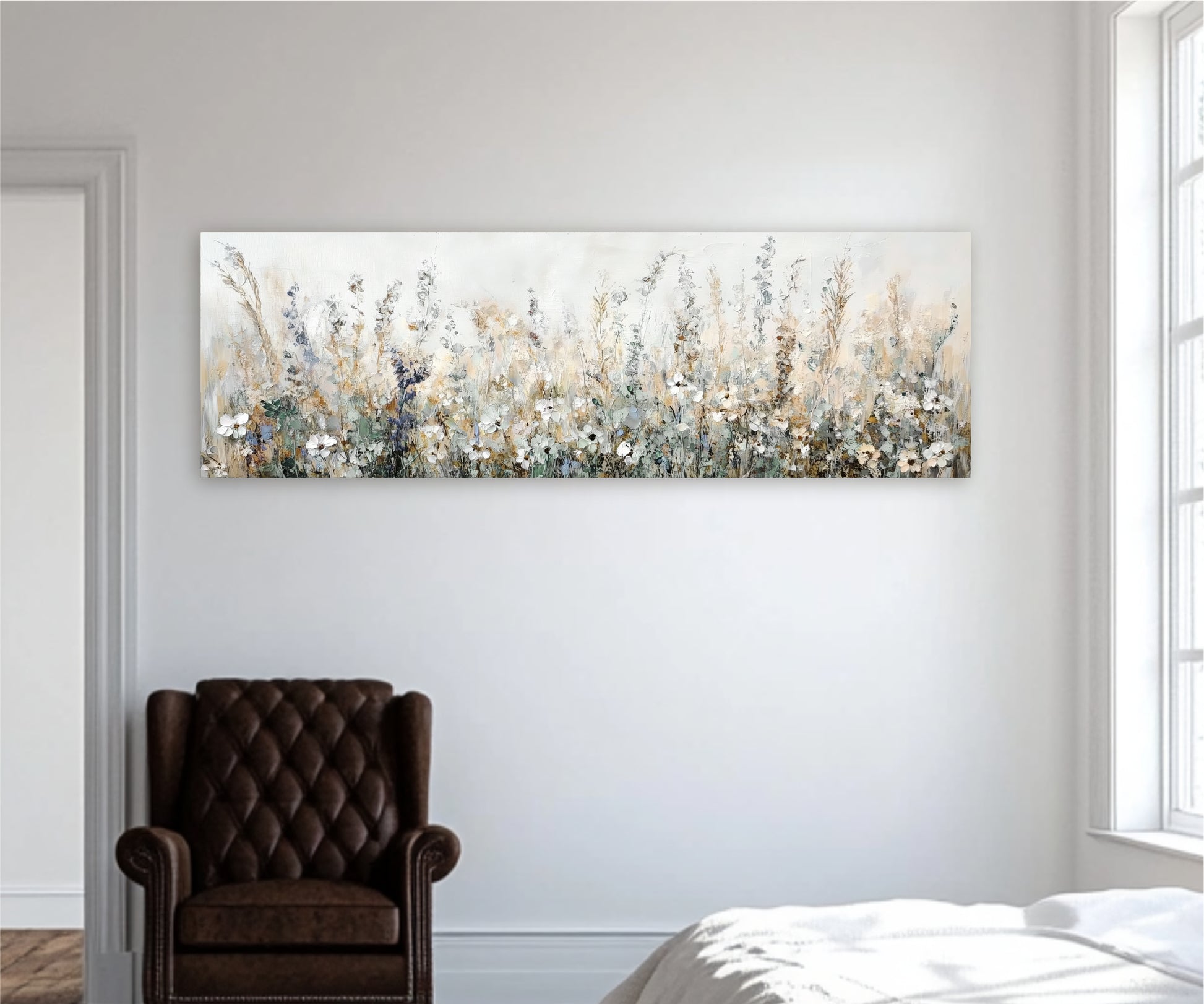 a large painting of a field of flowers hanging on a white wall above a brown leather armchair in a room with a window.